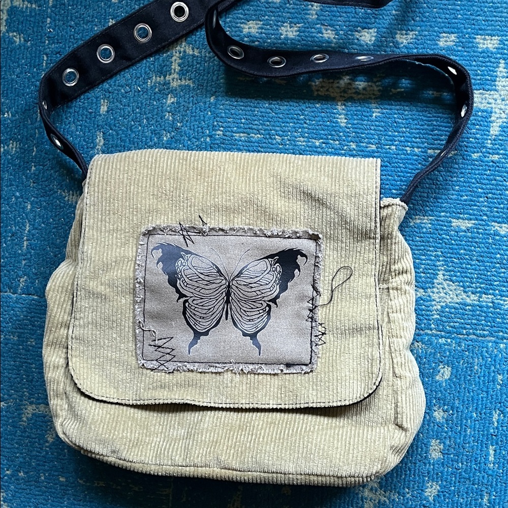 Hot Topic corduroy messenger bag with butterfly patch detail